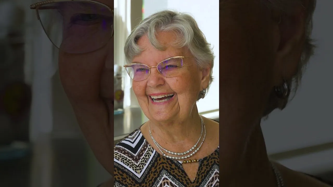 A smiling SYNERGY HomeCare client: play the video to hear from local families